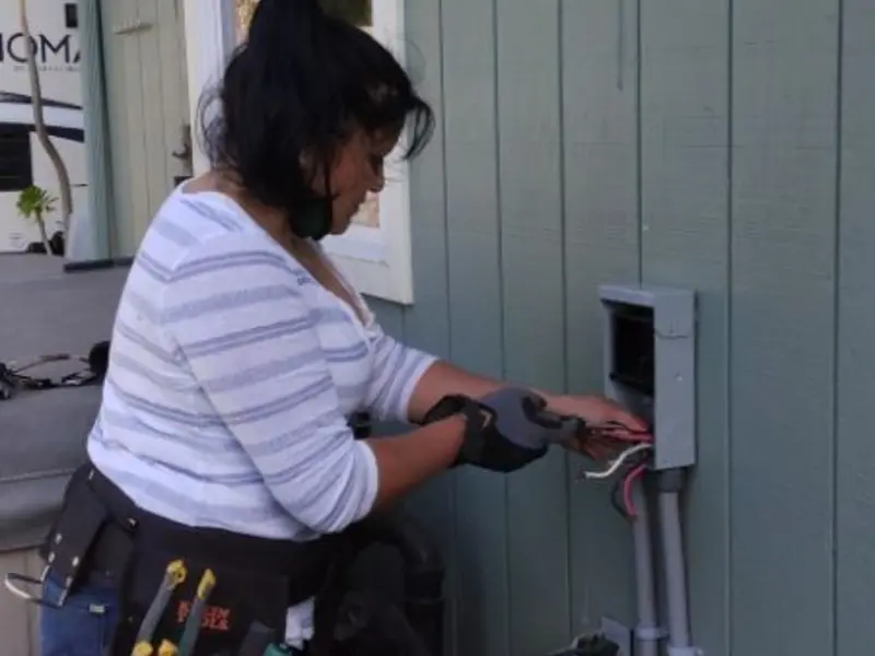 Licensed electrician wiring an exterior subpanel in Clarksburg
